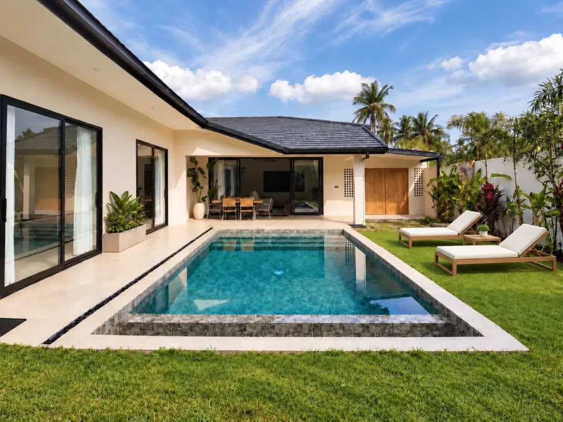 Daytime view of the private pool, covered terrace and garden at the Na Mueang villas