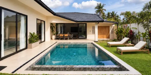 Daytime view of the private pool, covered terrace and garden at the Na Mueang villas