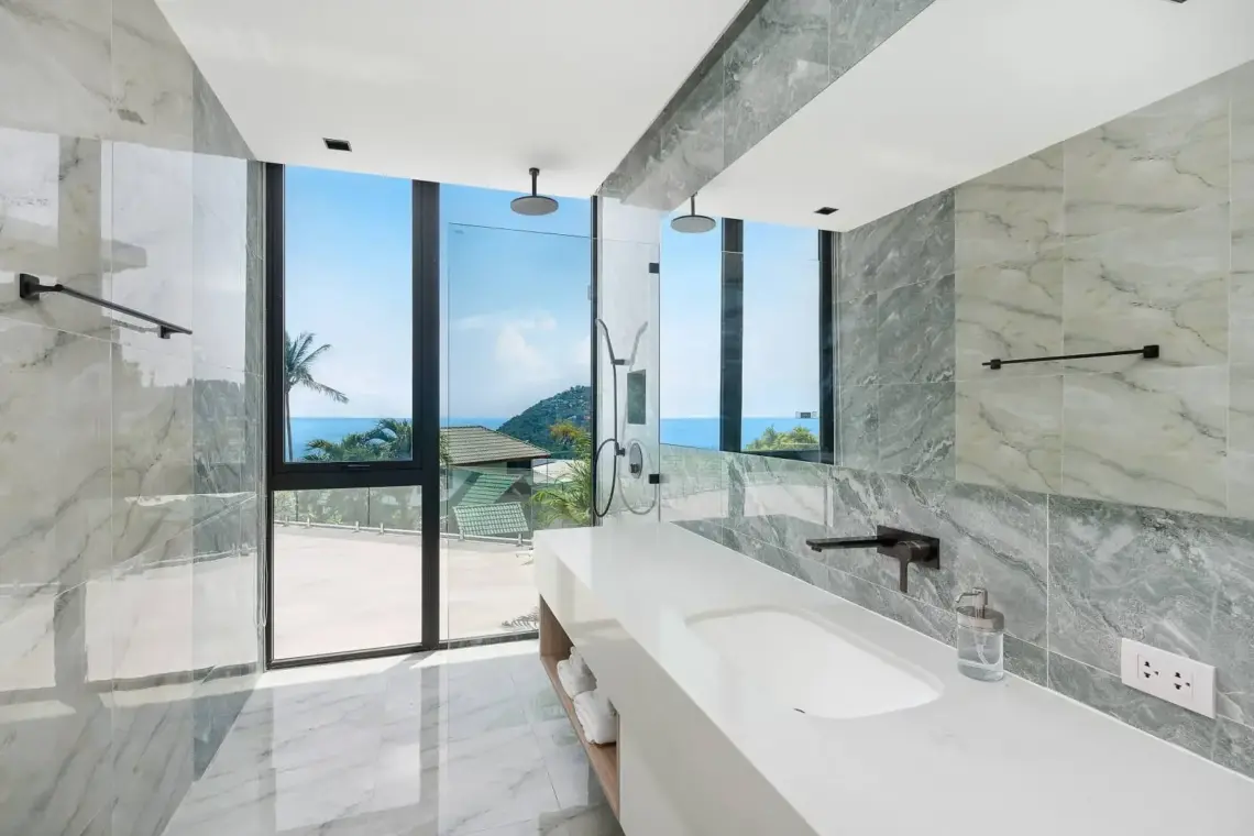 En-suite bathroom with double vanity and views towards the sea