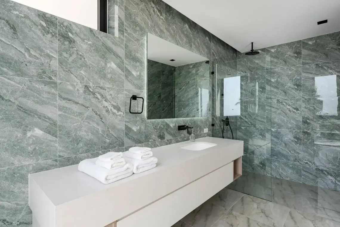 En-suite bathroom with stone finishes and a double vanity