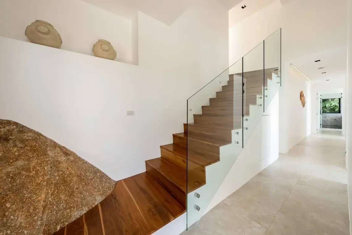 Teak staircase beside natural granite in a Chaweng Noi villa
