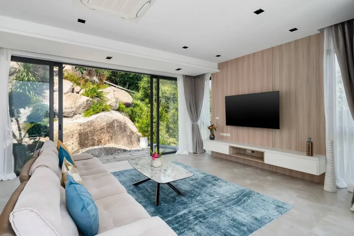 Living room with natural granite features and terrace glazing