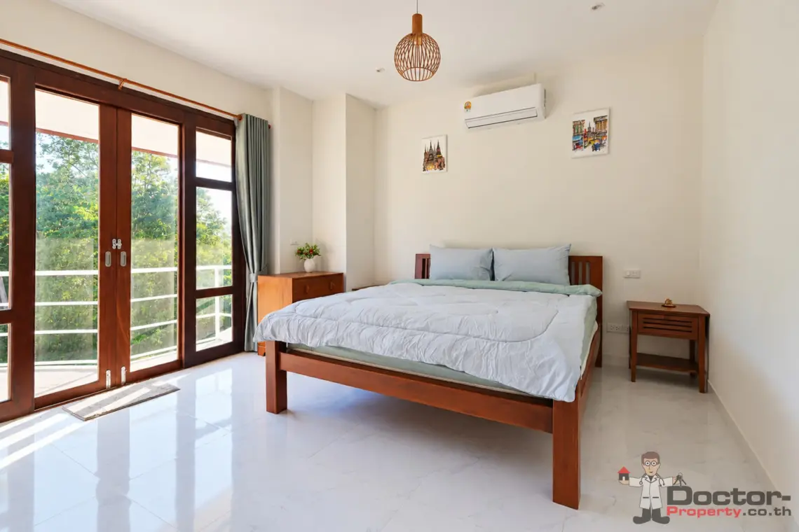 Bedroom with balcony doors at the 4 bedroom pool villa in Plai Laem, Koh Samui
