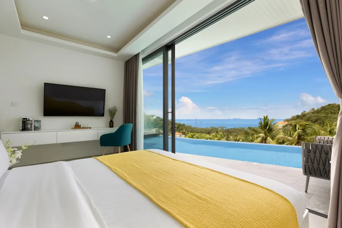 Bedroom overlooking the pool and sea