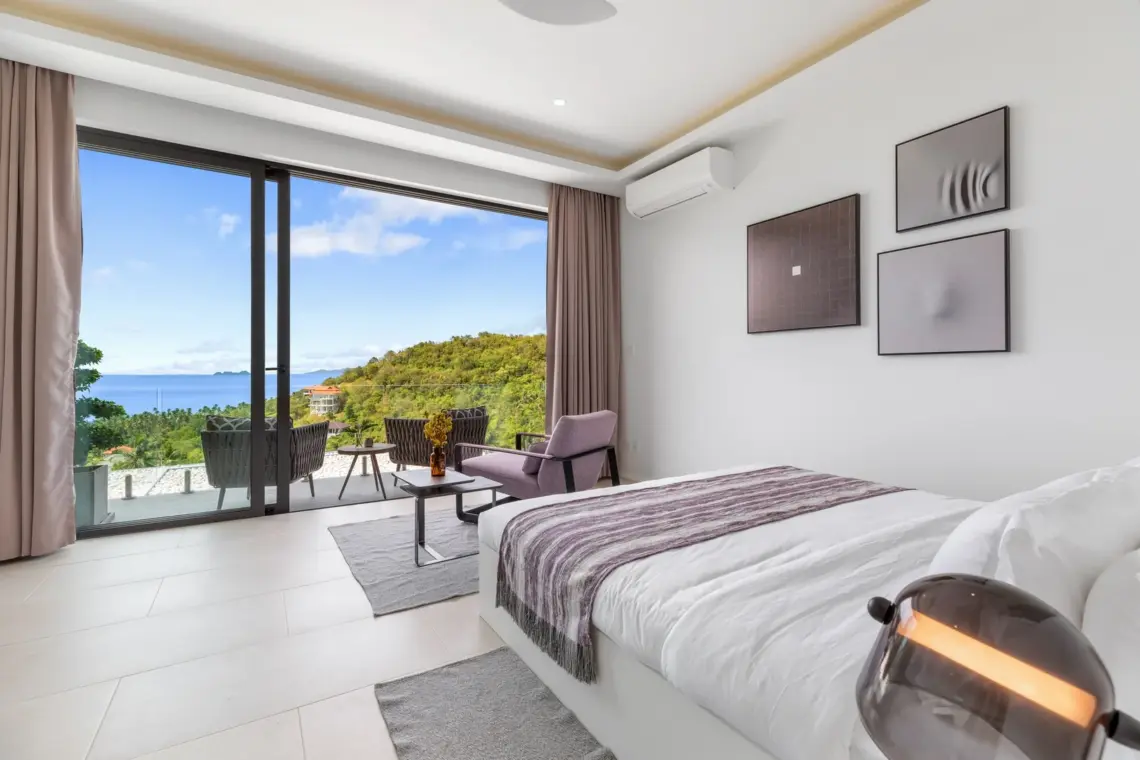 Bedroom with balcony seating and sea views
