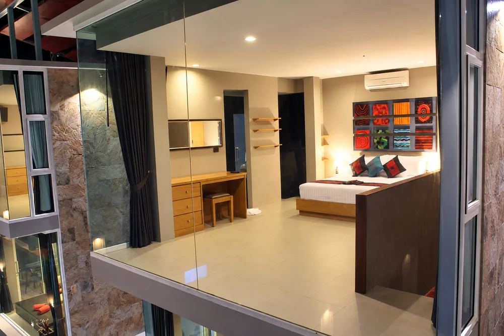 Bedroom through glass at a boutique hotel in Bang Rak, Koh Samui